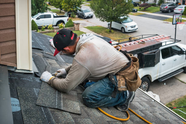 Professional Gutter Repair And Installation technician working in Malverne, NY